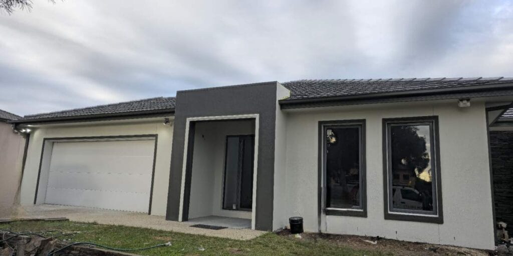 A freshly painted modern home exterior in Bendigo featuring crisp white walls, dark trim accents, and a clean contemporary façade after professional exterior painting services.