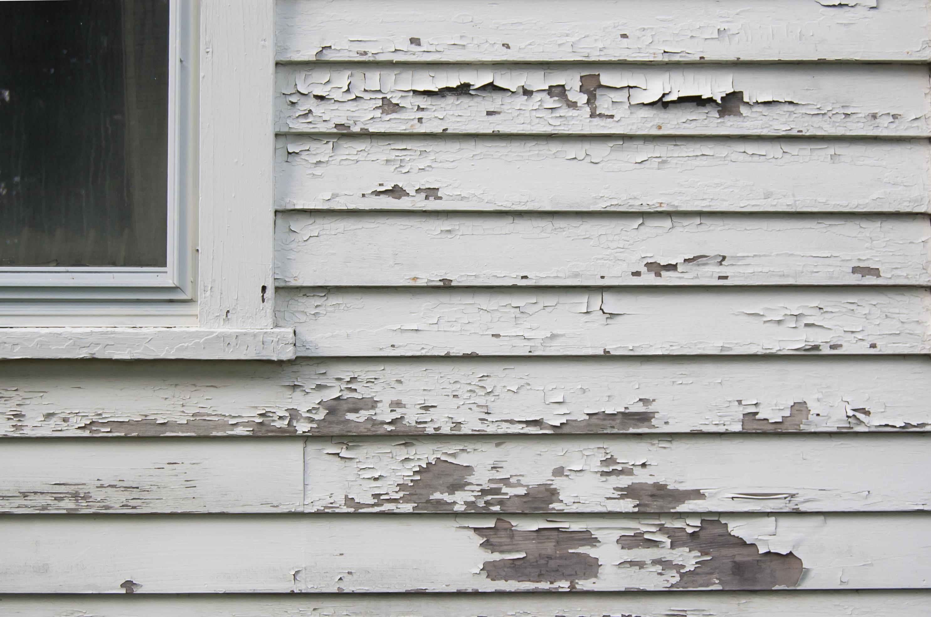 Peeling exterior paint on a weatherboard house in Bendigo