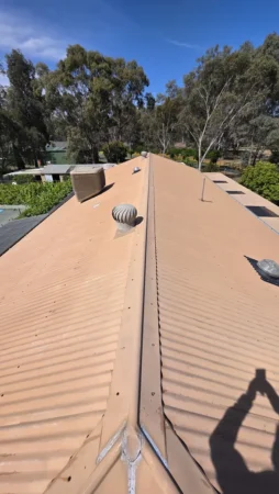 A faded tan metal roof with visible wear before receiving professional roof painting and repair services in Bendigo, highlighting deterioration and colour loss.